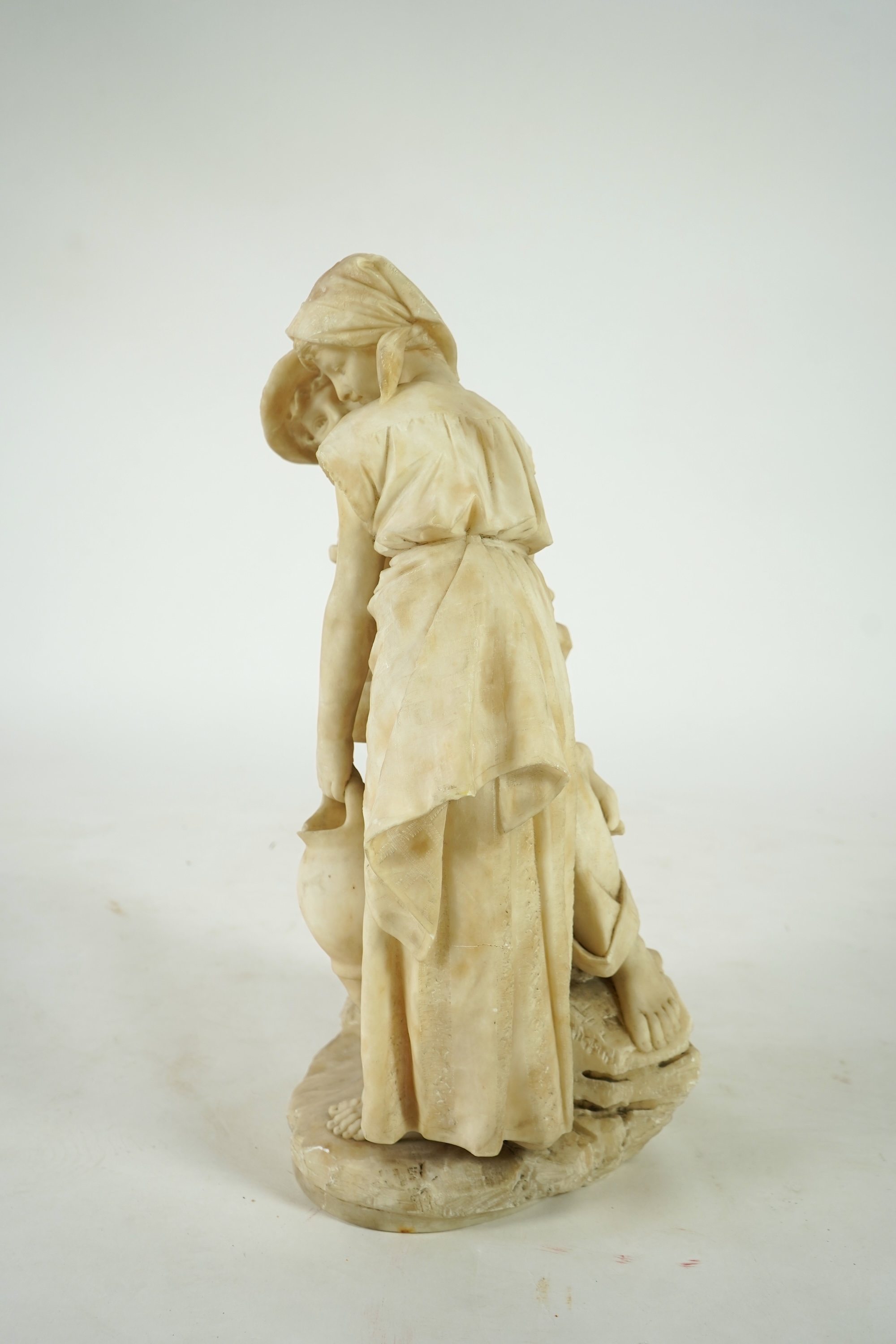 A large Continental alabaster group of a peasant couple, late 19th / early 20th century